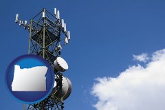 oregon map icon and a telecommunications tower, with blue sky background